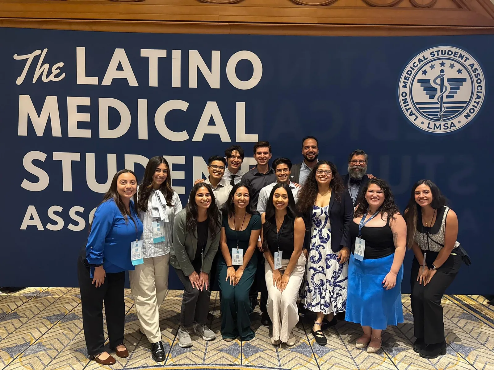 Group in front of the blue Latine Medical Student Association banner at the 2025 National Conference.