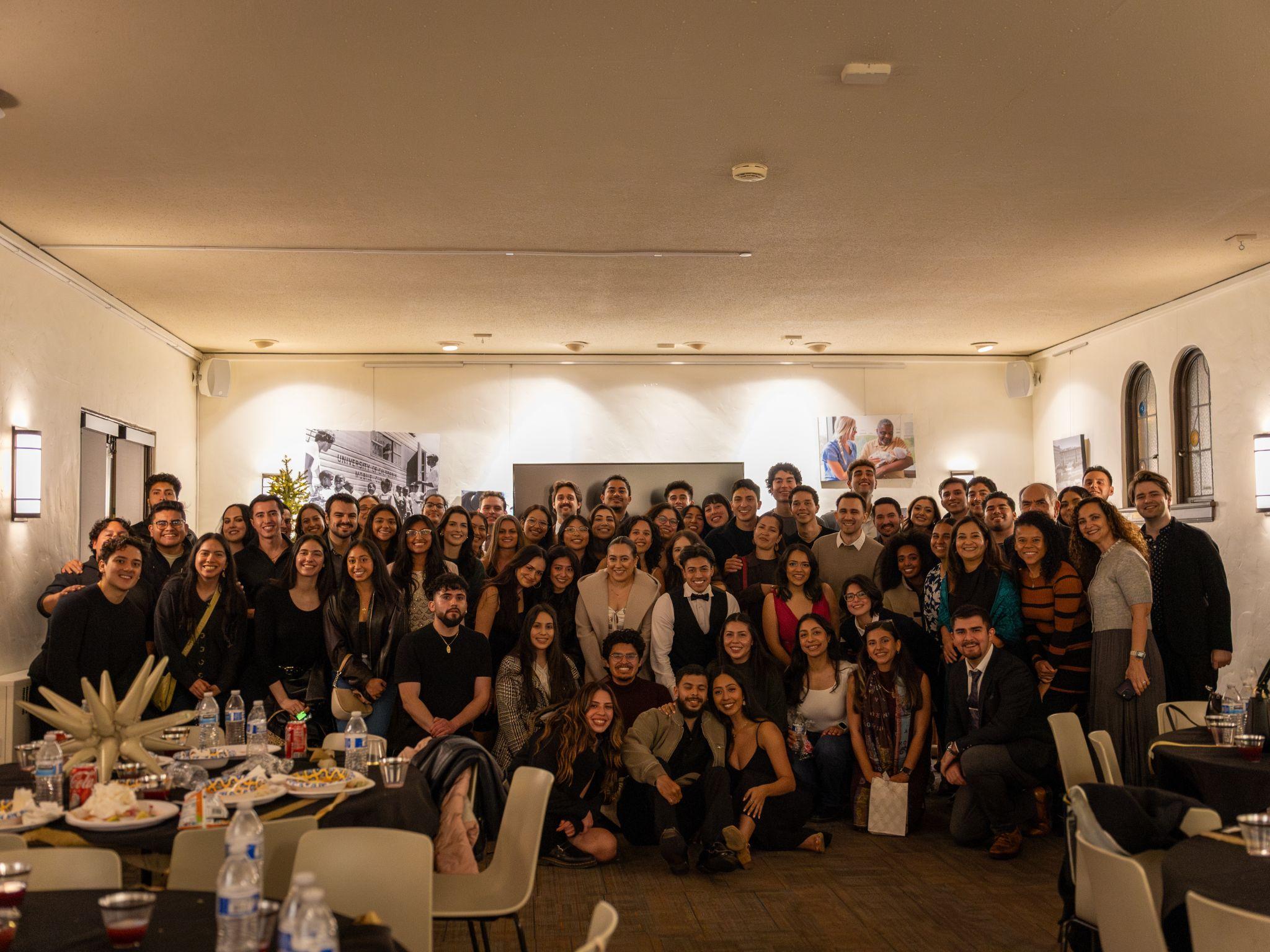 Large group posing together at Winter Pachanga 2025, a formal end-of-year celebration.