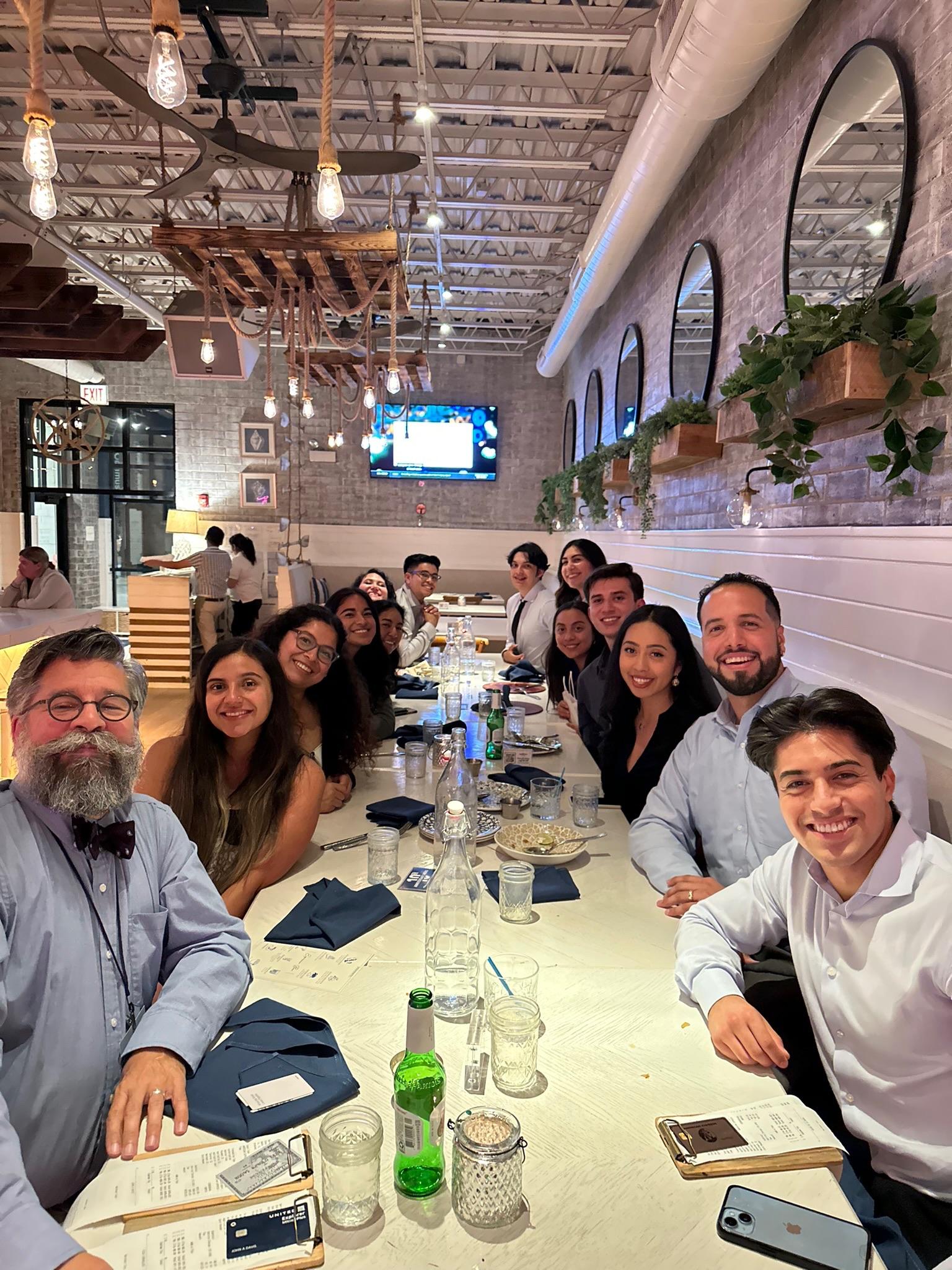 LMSA at UCSF members sharing dinner at a long restaurant table during the 2025 National Conference.